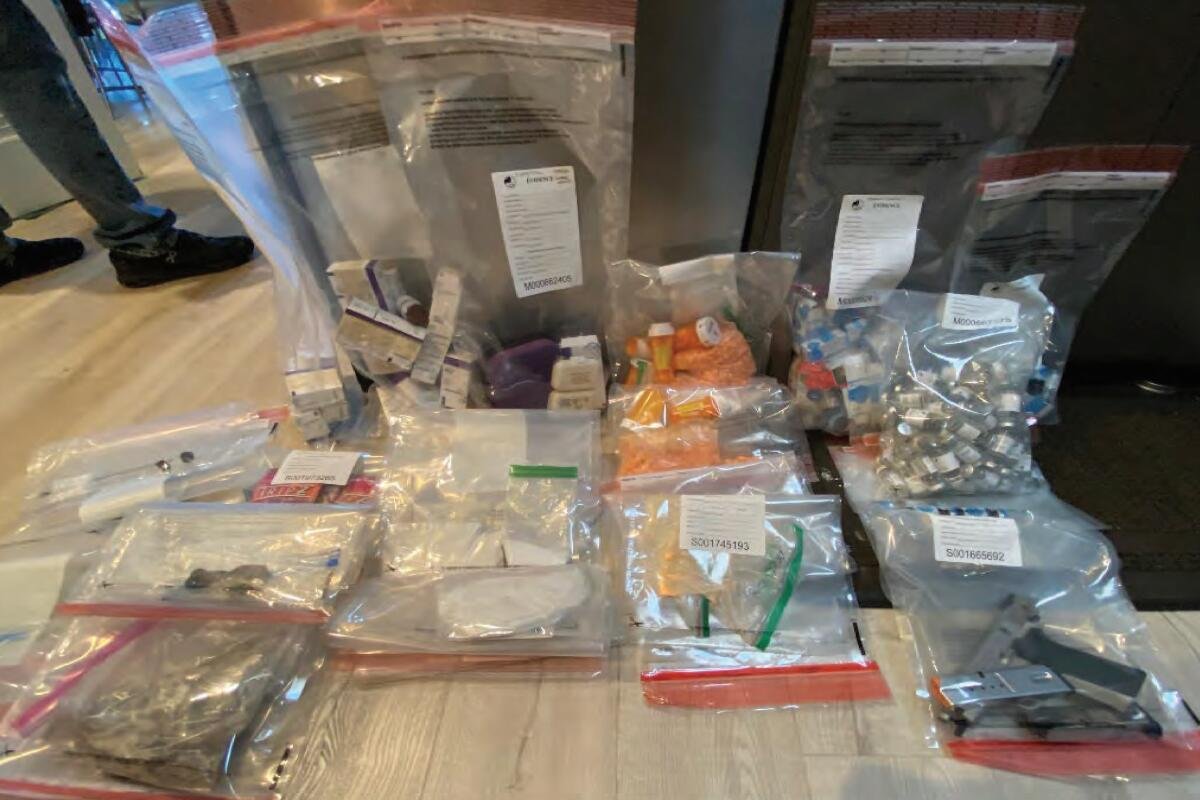 Clear plastic bags filled with evidence are placed on the table.